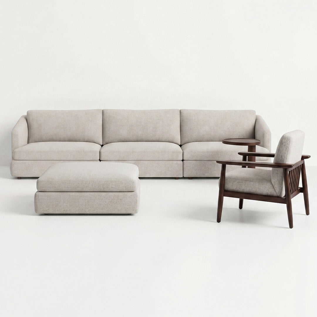 Beige sectional sofa with a matching armchair on a white background
