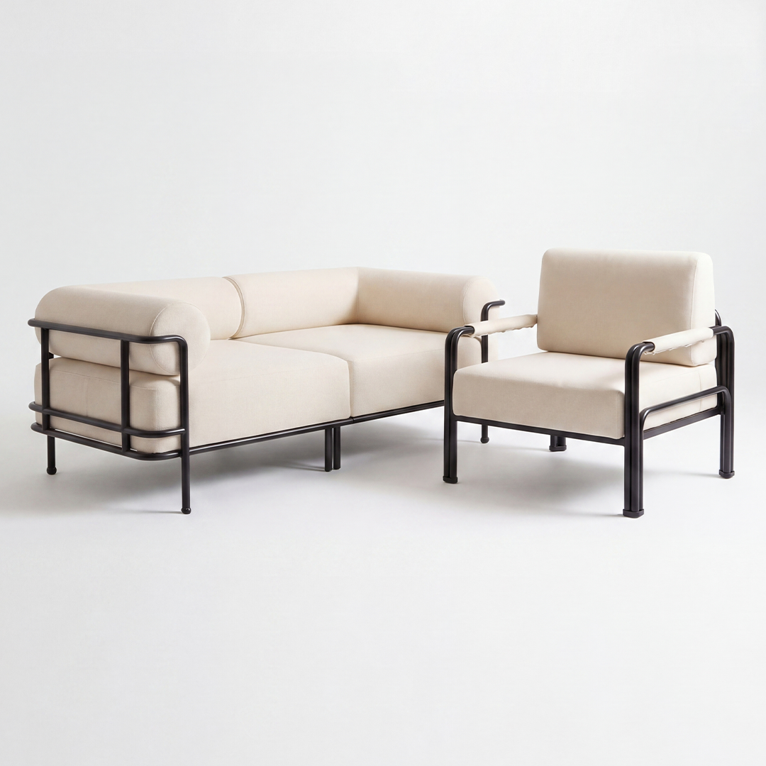 Beige sofa and chair set with black metal frames on a white background